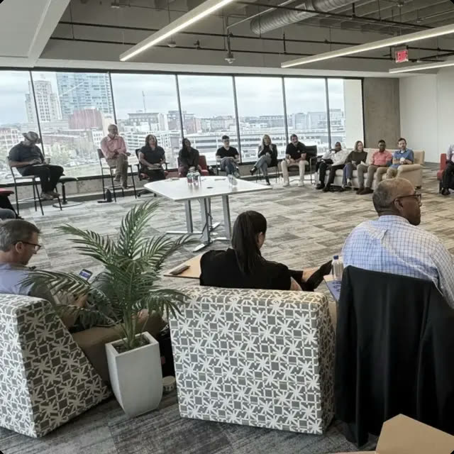 Community members seated in a circle during a Friday coffee conversation